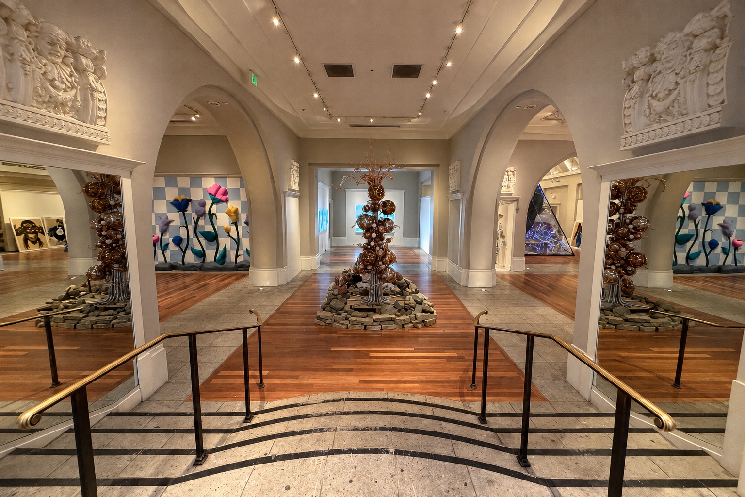 Inside the Coliseum of Art, with arched galleries, glass flowers, and warm wood floors.