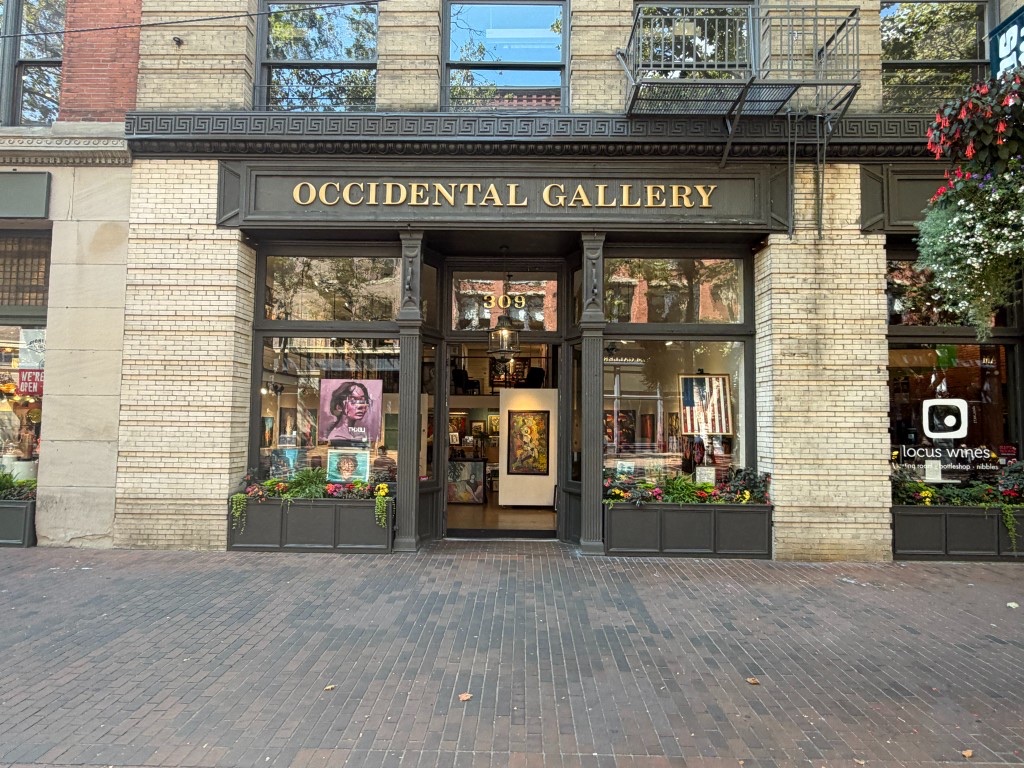 Occidental Gallery storefront at 309 Occidental Ave S — gold sign, daylight, Pioneer Square